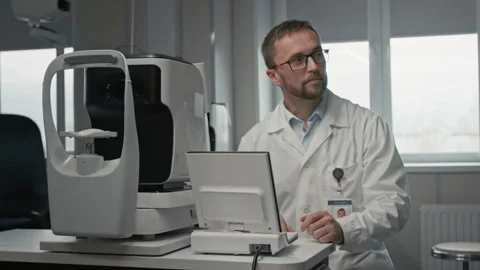 Doctor Sitting at Diagnostic Machine Stock Footage 322692048