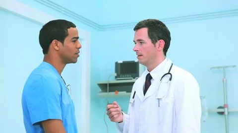 Doctor speaking to a colleague Stock Footage