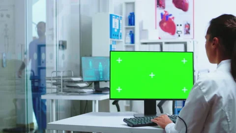 Doctor specialist using computer with green screen Stock Footage 135656840