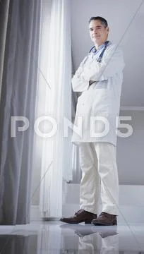Doctor Standing In Front Of Window