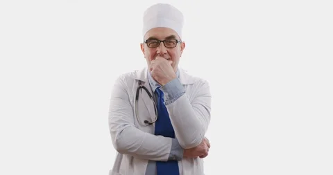 Doctor standing on white background thinks, slowmotion, 6k. Stock Footage 128549575