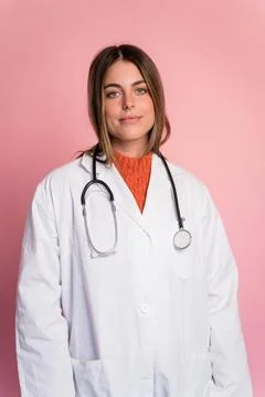 Doctor with stethoscope on pink background Stock Photos