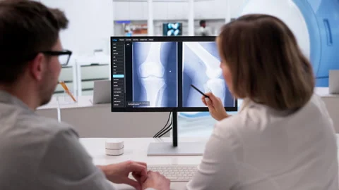 Doctor Studies Knee X-ray Carefully Stock Footage 332907205