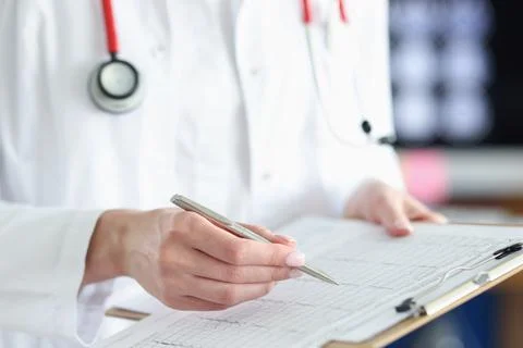 Doctor is studying decoding of cardiogram of patient heart Stock Photos