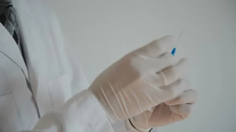 Doctor with syringe is preparing for injection Stock Footage 55958868