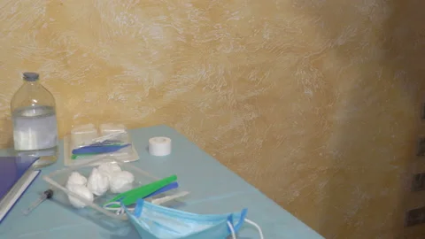 Doctor at the table puts on a mask Stock Footage 126696104
