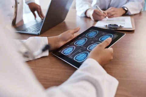 Doctor, tablet screen and hands of person with brain scan MRI, cancer tumor Stock Photos