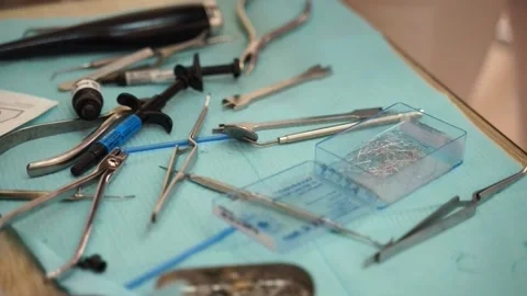 The doctor takes the necessary instruments from the table for treatment Video stock 167303651