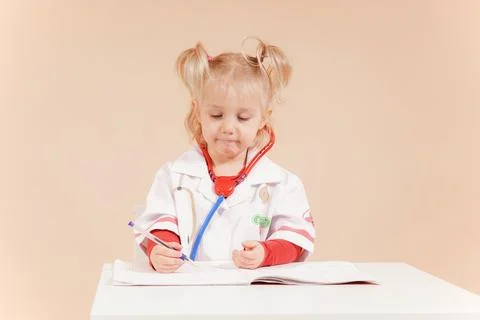 Doctor takes notes in a notebook and listens attentively to the patient. Stock Photos
