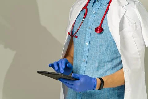 The doctor takes notes in the tablet. remote or distance medicine concept Stock Photos