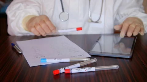 Doctor taking notes about the coronavirus nasopharyngeal swab positive tests 库存影片 128768795