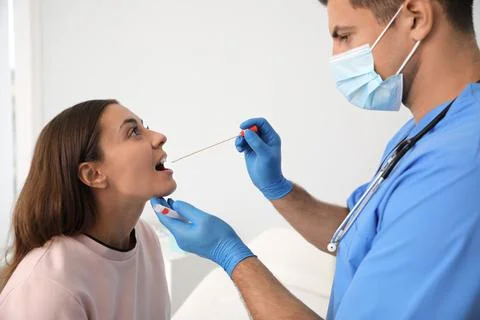 Doctor taking sample for DNA test from woman in clinic 스톡 사진