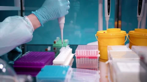 Doctor taking samples from blue tray and putting them in PCR tubes and from Stock Footage 236962534