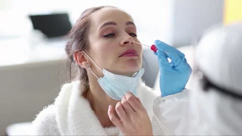 Doctor taking swab from nose with to woman patient 4k movie slow motion Stock-Footage 260415839