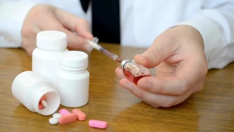 Doctor taking syringe preparing for the injection of syringe from an ampoule Stock-Footage 336587105