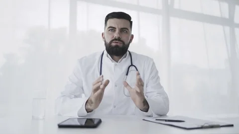 Doctor talking and looking at camera. 4K Stock Footage 77876644