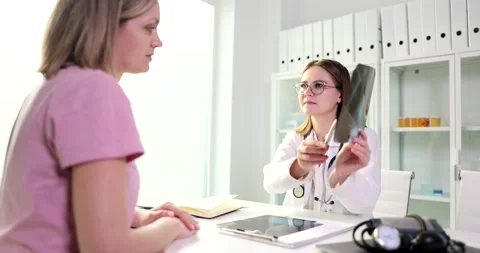 Doctor is talking and looking at x-ray film with picture of lungs Stock Footage 234599451