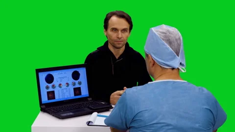 Doctor talking with patient while sitting next to laptop against green screen Stock Footage 126339958