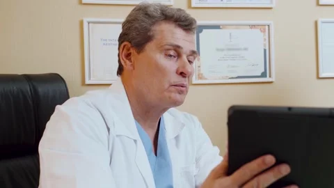 Doctor talking to patient while sitting at clinic. Stock Footage 146177075