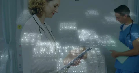 Doctor tapping tablet launching patient data overlay while nurse noting folder Stock Footage 320205455