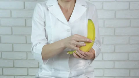 The doctor teaches how to use a condom. Stock Footage 149146814