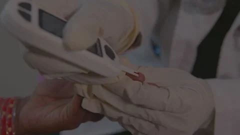 Doctor testing a patient's sugar Stock Footage 249496188