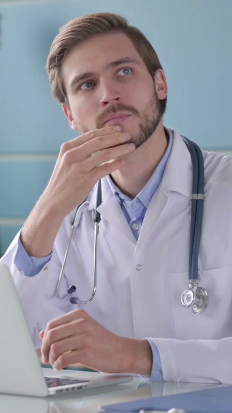 Doctor Thinking while Working on Laptop in Office, Vertical Video Stock Footage 339579958