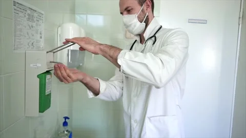 The doctor thoroughly washes his hands Stock Footage 130671287