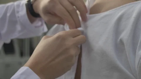 Doctor ties a straitjacket to a madman Stock Footage 126000198