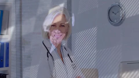 Doctor turning toward camera and smiling, initiating globe graphic appearing Stock Footage 332704248