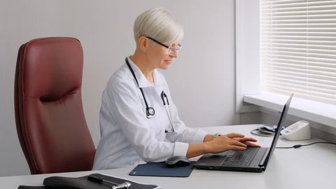 Doctor typing on the computer. Reception at the doctor's office. Stock Footage 112146507