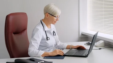 Doctor typing on the computer. Reception at the doctor's office. Stock Footage 112146509