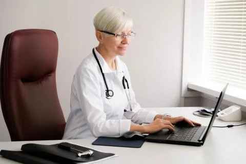 Doctor typing on the computer. Reception at the doctor's office. Stock Photos