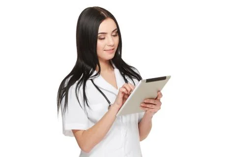 Doctor in uniform using tablet and reading information about patient Stock Photos