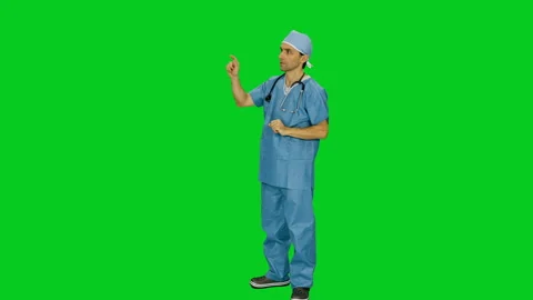 Doctor in uniform using virtual display against green screen Stock-Footage 124555755