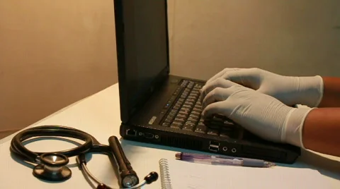 A doctor updates his notes Stock Footage 710097
