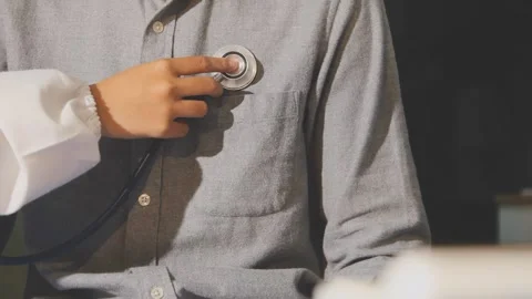 Doctor use stethoscope, checking up heart beat, auscultation in doctor offi.. Stock Footage 343709138
