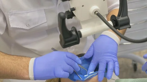 Doctor used microscope. Dentist is treating patient in modern dental office Video stock 90515079