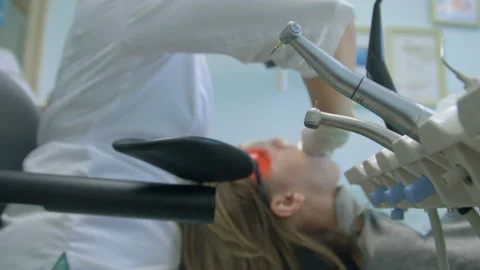 Doctor Used Microscope. Dentist Is Treating Patient In Modern Dental Office Video stock 94386620