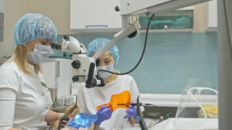 Doctor used microscope. Dentist is treating patient in modern dental office Video stock 98468418
