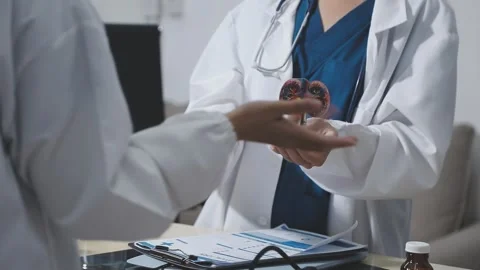 Doctor uses anatomical model to explain male urinary system. Model labeled .. Stock Footage 332664595