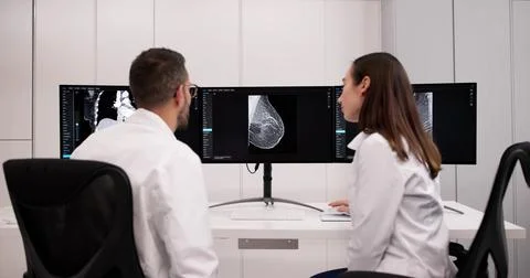 Doctor Uses Computer Imaging To Screen For Breast Cancer Tumors. Stock Photos