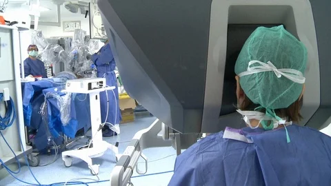 Doctor uses robotics - visual from behind Stock Footage 97170891