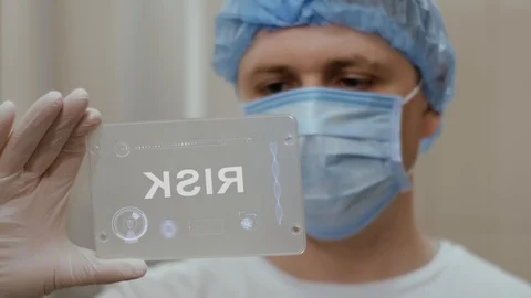 Doctor uses tablet with text Risk Video stock 112055675