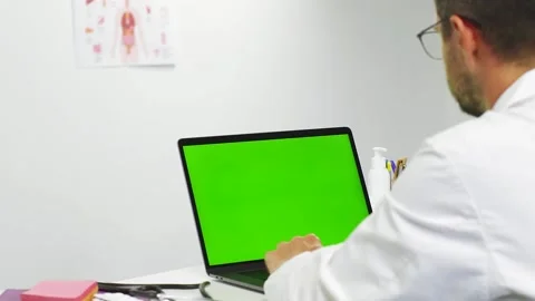 Doctor using chroma key personal computer at hospital Video stock 135913965