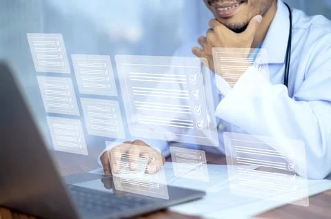 Doctor using computer Document Management System (DMS), online documentatio.. Stock Photos