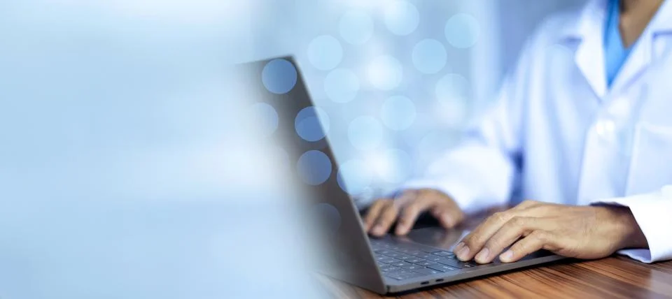 Doctor using computer in office. Stock Photos