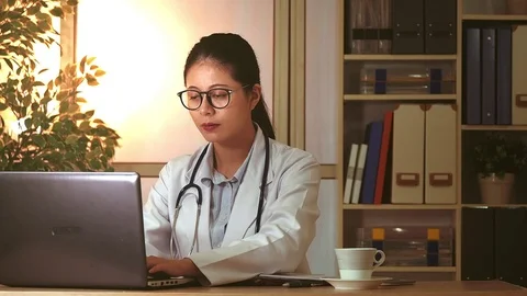 Doctor using computer to research internet Video stock 70261492