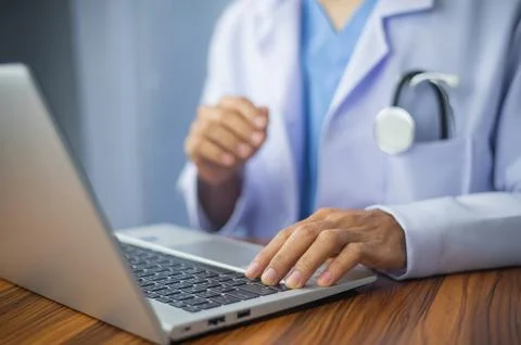 Doctor using computer typing on keyboard. Doctor computer Stock Photos