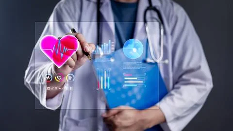 Doctor using digital interface with heart rate monitor and medical charts. .. Stock Photos
